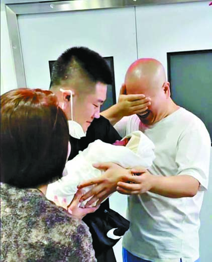 ■王小利（右1）在产房外看到孙子疑似激动擦眼泪。 网上图片